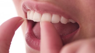 Woman-Floss-Teeth-Close-up